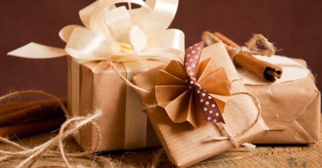 Different corporate gifts wrapped in brown paper.