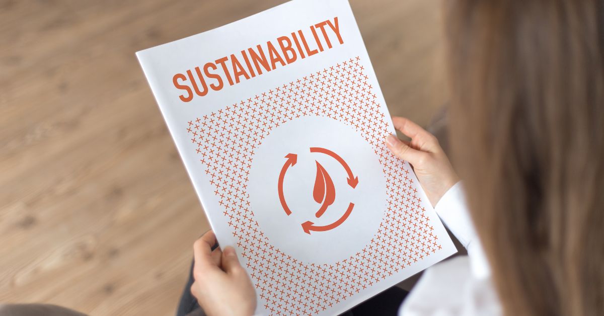 A woman reading a brochure about sustainability.