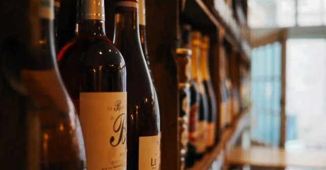 Different wine and liquor bottles in a shelve.