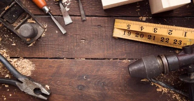 A wooden table with woodworking tools laid out ready for work.